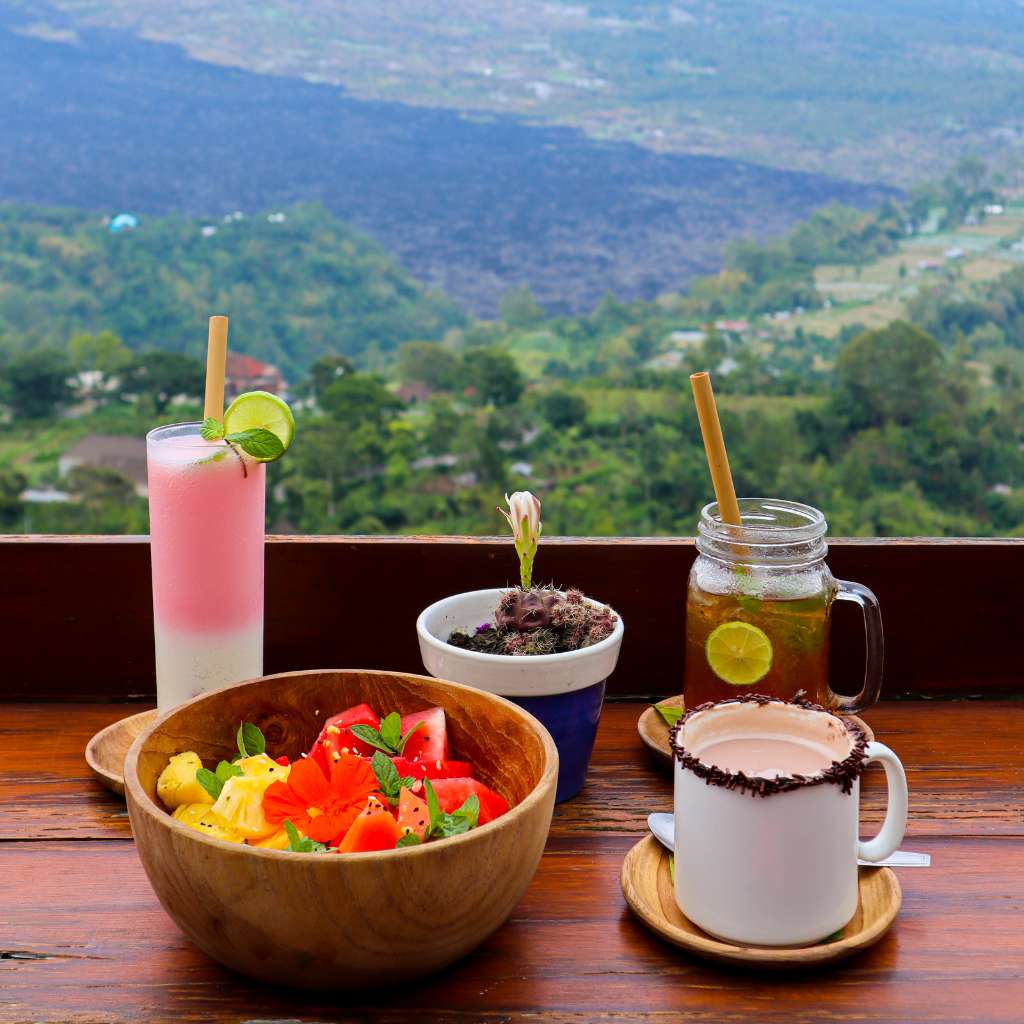 Eating food facing to beautiful Kintamani mountain